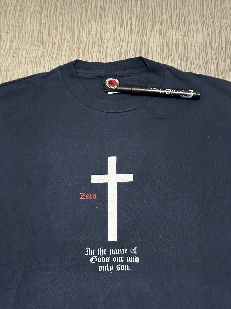 Vintage Zero Skateboards Jamie Thomas (Category: Tshirts & Polo Shirts ) located in Bacoor. Submitted by realbacktrack (Listing ID 1459697282, Image 2). Description: - Navy blue Zero t-shirt - Features a white cross graphic with 'Zero' in red - Text below reads 'In the name of God's one and only son.' - Zero logo on the sleeve - From the Tum-Yeto brand - Ideal for skateboarders and fans *23.5 x 29.7 Hairlines 9/10 color rate *color may vary due t