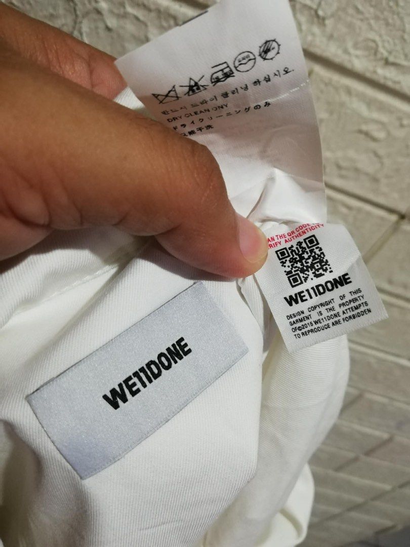 WE11DONE White Oversized Shirt with Unique Buttons (Category: Tshirts & Polo Shirts ) located in Rizal. Submitted by tiangarcia02 (Listing ID 1459814706, Image 2). Description: - Authentic WE11DONE white long-sleeved shirt - Unique large silver button-down front - Relaxed, oversized fit - Versatile for layering or standalone wear - Refer to label for care instructions.