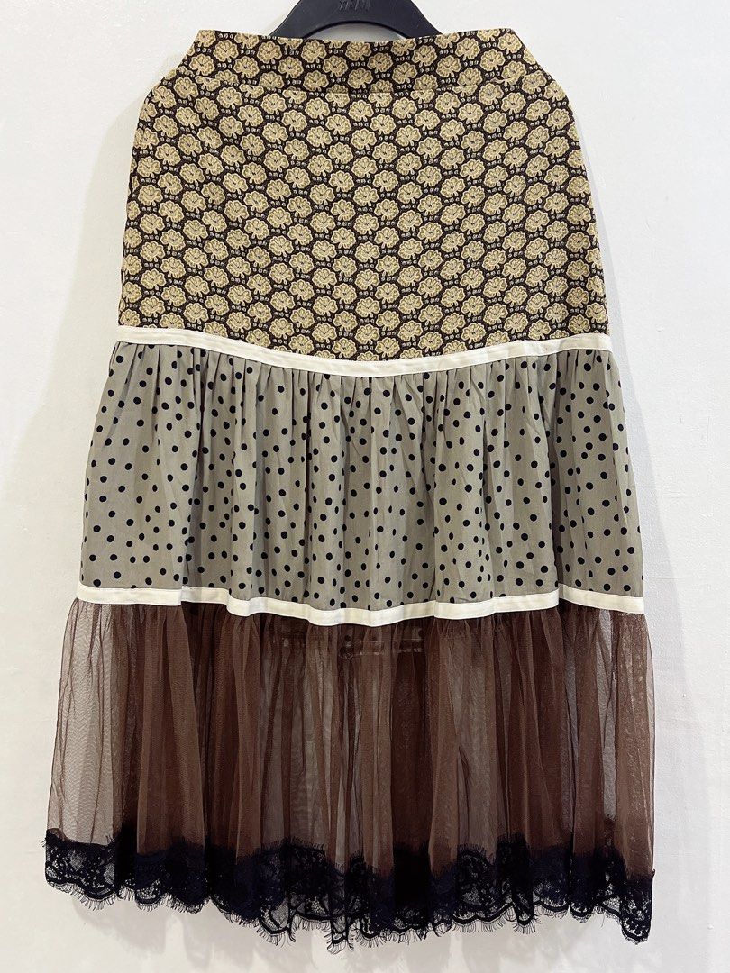 Rare Whimsical / Cottage core skirt (Category: Skirts) located in Cavite. Submitted by wishie_collects (Listing ID 1459803889, Image 2). Description: Design: A whimsical, multi-tiered midi skirt featuring three distinct patterned sections divided by white piping lines. Details: It starts with a brown and beige floral print yoke, flows into an olive green polka-dot ruffled tier, and finishes with a sheer brown tulle layer trimmed with delicate bla