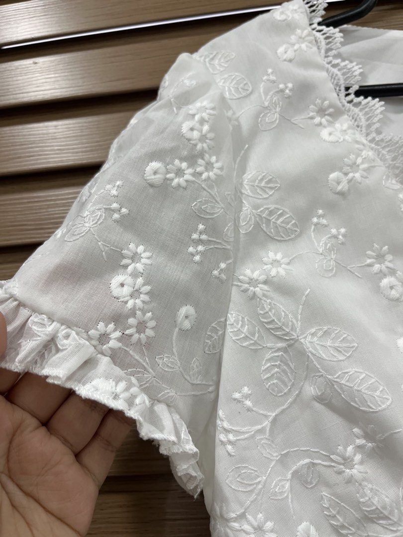White Embroidered Button-Up Crop Top XS (Category: Blouses) located in Mabalacat. Submitted by fashionclothesph (Listing ID 1459822655, Image 3). Description: - Cute white crop top - Floral embroidery detail - V-neckline - Button-up front - Short sleeves with ruffled cuffs - Versatile for pairing with jeans or skirts - Ideal for casual outings or summer picnics.