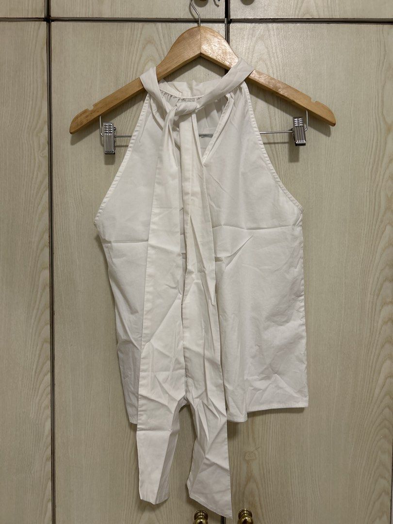 White Halter Neck Top with Tie Detail (Category: Sleeveless) located in Makati City. Submitted by leannd (Listing ID 1459782892, Image 2). Description: - White halter neck top - Features a tie detail at the back - Simple and chic design - Versatile for casual outings or dressing up - Easily pairs with skirts or pants.