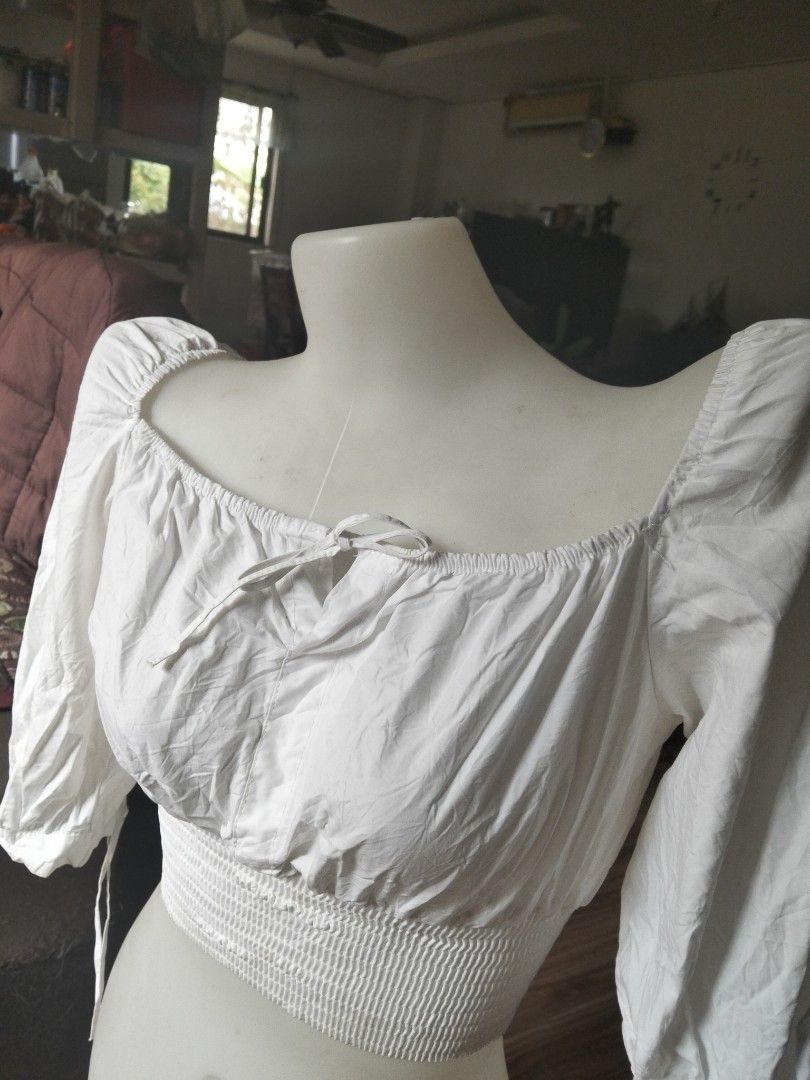 White Smocked Square Neck Crop Top (Category: Sleeveless) located in Bulacan. Submitted by kikay2000 (Listing ID 1459783861, Image 2). Description: - White crop top - Smocked waist for a flattering fit - Square neckline with adjustable tie detail - Chic puff sleeves ending at the elbow - Ties at the sleeve ends for a customizable look - Effortlessly pairs with high-waisted bottoms.