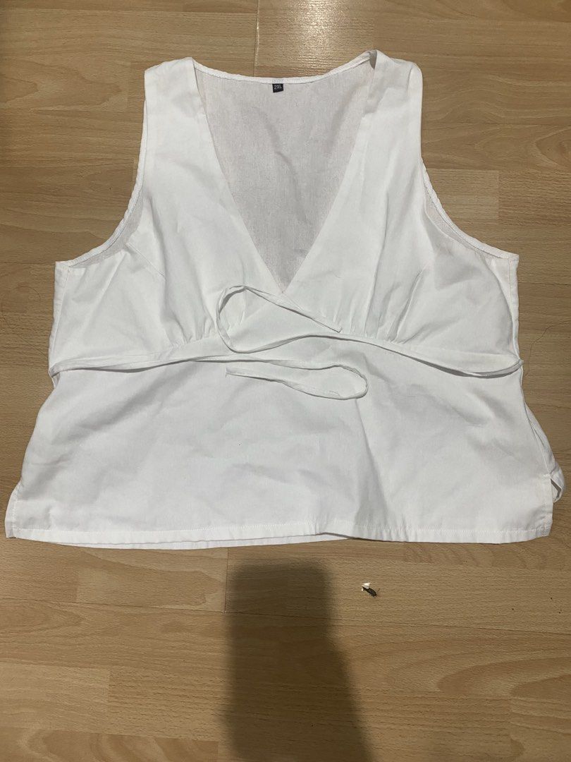 White v neck with ties (Category: Sleeveless) located in Caloocan City. Submitted by d3clutt3r1ng (Listing ID 1459747679, Image 1). Description: - never used, tried on only, washed already - have to wear pasties with this, v neck is too deep to wear strapless bra (will show) - too big and low for me - presko.