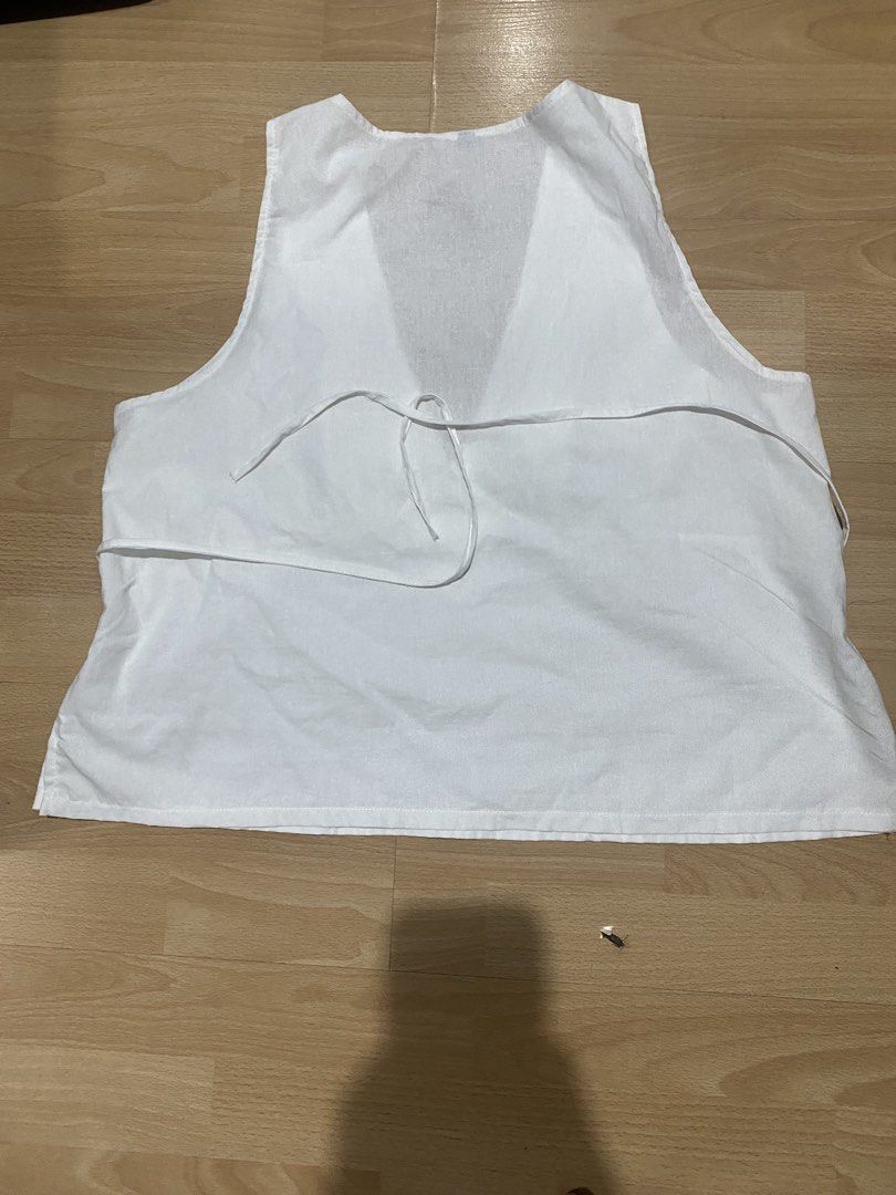 White v neck with ties (Category: Sleeveless) located in Caloocan City. Submitted by d3clutt3r1ng (Listing ID 1459747679, Image 2). Description: - never used, tried on only, washed already - have to wear pasties with this, v neck is too deep to wear strapless bra (will show) - too big and low for me - presko.