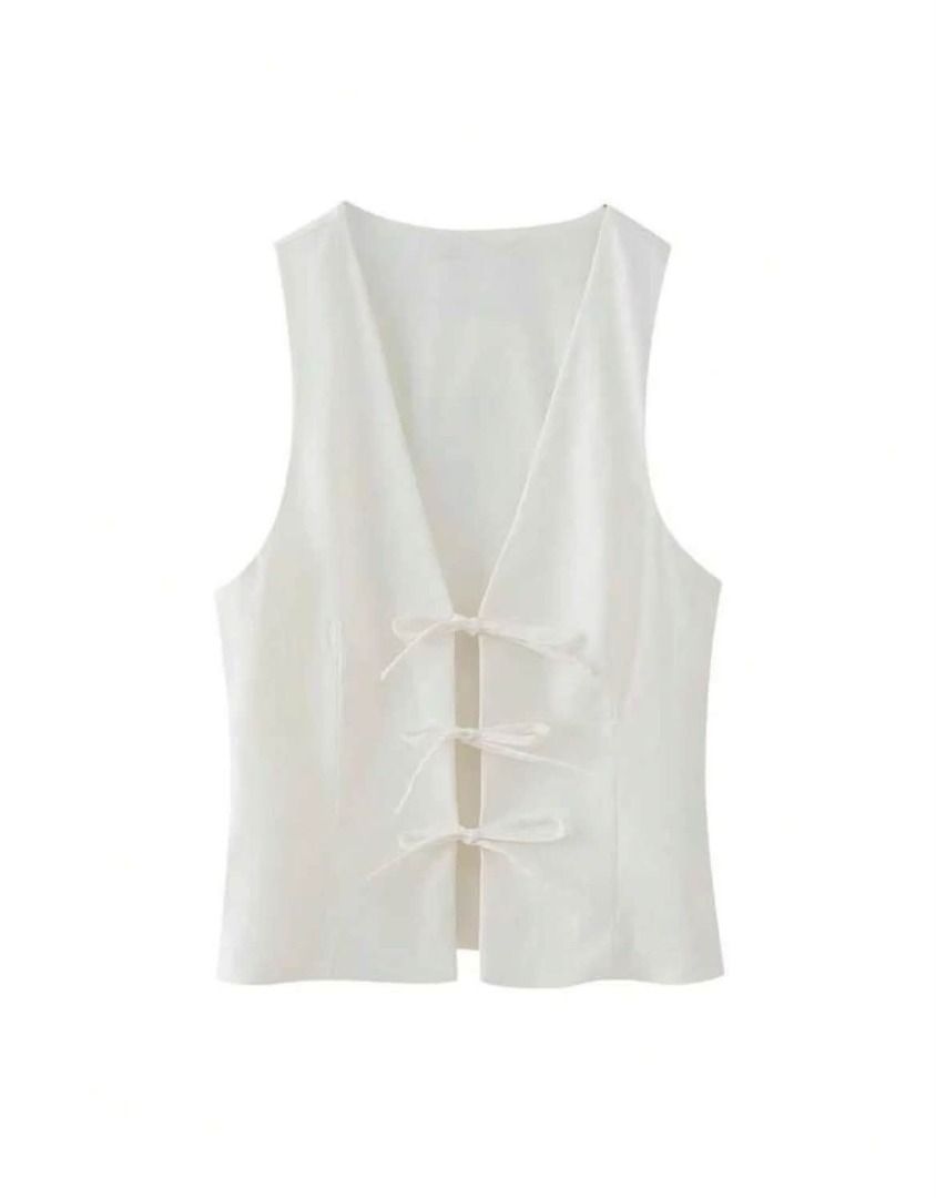 White V-Neck Sleeveless Vest with Tie Front (Category: Sleeveless) located in Manila. Submitted by notsobella_ (Listing ID 1459857487, Image 1). Description: CONDITION: GOOD SIZE: SMALL.