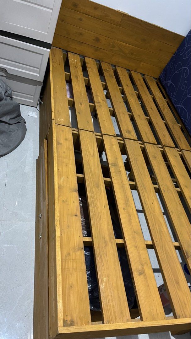 Wooden Bed Frame with Headboard (Category: Bed Frames & Mattresses) located in Pasay City. Submitted by maxiiii.rabbit (Listing ID 1459771793, Image 3). Description: - Sturdy wooden bed frame - Includes wooden headboard - Slatted base - Minor scuffs on wood - Mattress not included - Ready for pickup -Size is Double 54x75 inches (137 x 190 cm).