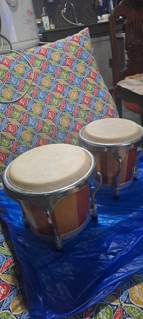 Wooden Bongo Drums with Metal Hardware (Category: Musical Instruments) located in Quezon City. Submitted by chrisconradbautista (Listing ID 1459744480, Image 2). Description: - Pair of wooden bongo drums - Natural wood finish with contrasting stripes - Metal hardware and tension rods - Small size, ideal for beginners or practice - Produces a great sound - Ready for a new home Mini Bongo Drums Japan In very good condition sizes shown on pictures s