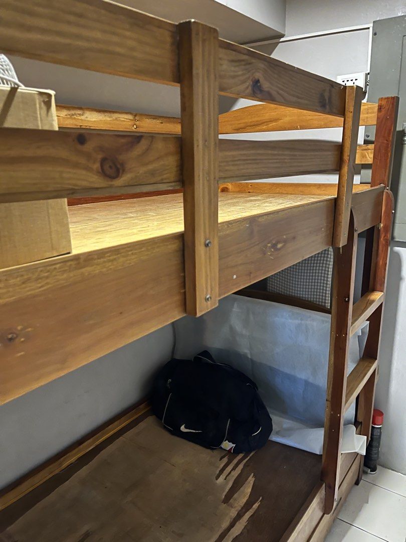 Wooden Bunk Bed with Drawers (Category: Bed Frames & Mattresses) located in Taguig. Submitted by anina.anina (Listing ID 1459801651, Image 3). Description: Solid Mahogany wood bunk bed for sale. Custom made. Very sturdy. Great space-saving solution. - Includes ladder for top bunk - Bottom bunk features built-in storage drawers - Natural wood finish - Parts may be dismantled Some cosmetic damage mainly on the bottom plywood. Dimensions are: 203 cm