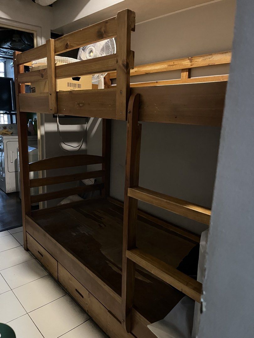Wooden Bunk Bed with Drawers (Category: Bed Frames & Mattresses) located in Taguig. Submitted by anina.anina (Listing ID 1459801651, Image 1). Description: Solid Mahogany wood bunk bed for sale. Custom made. Very sturdy. Great space-saving solution. - Includes ladder for top bunk - Bottom bunk features built-in storage drawers - Natural wood finish - Parts may be dismantled Some cosmetic damage mainly on the bottom plywood. Dimensions are: 203 cm
