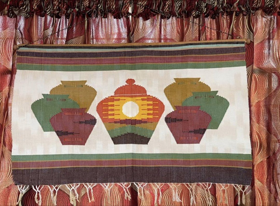 Woven Wall Hanging Tapestry with Pot Design (Category: Wall Decor) located in Manila. Submitted by immrsa (Listing ID 1459898359, Image 1). Description: - Handwoven tapestry - Features a central design of pots with a sun motif - Colors: Earthy tones, green, and burgundy - Decorative fringe detail at the bottom - Ideal for bohemian or rustic wall decor - Approximate dimensions: [insert width] x [insert height] Bought in Baguio Excellent condition 