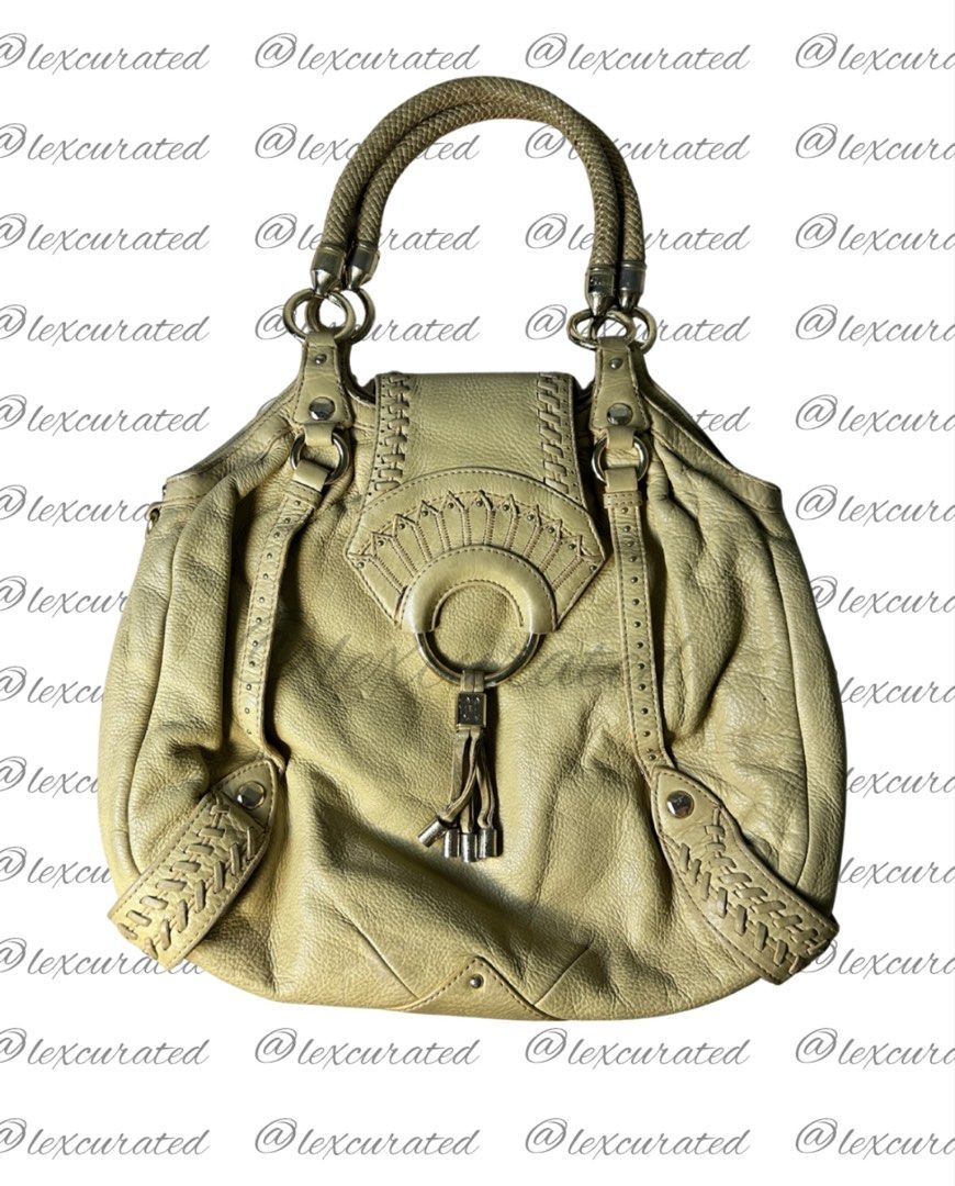 Y2K Cole Haan Leather Shoulder Bag (Category: Shoulder Bags) located in Manila. Submitted by lexcurated (Listing ID 1459853555, Image 1). Description: - Light yellow genuine leather handbag - Unique braided detailing on the sides - Comfortable rope-style handle - Adorned with a tassel charm with metal accents - Ideal for everyday wear.