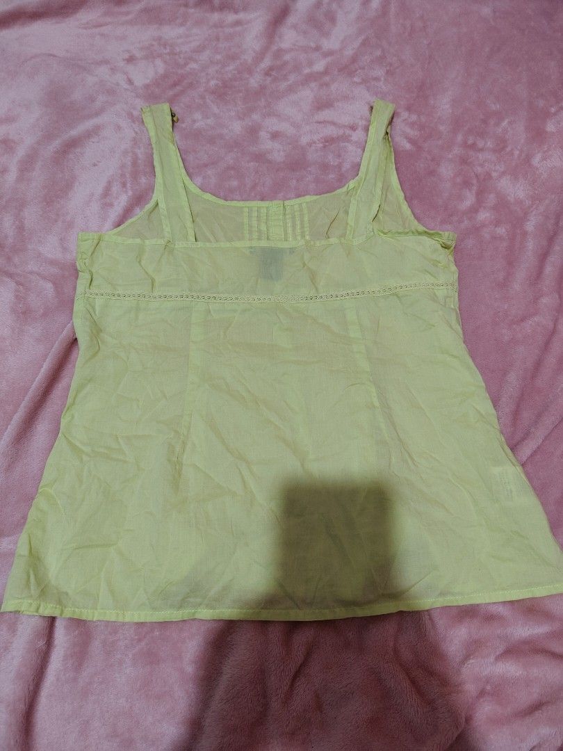 y2k Eddie Bauer Yellow Button-Up Tank Top (Category: Sleeveless) located in Villasis. Submitted by trip_thrift15 (Listing ID 1459726387, Image 2). Description: - Yellow tank top from Eddie Bauer - Square neckline with button-up front - Pintuck details on the bodice - Lace trim above bust and at hem - Thin straps - Made of 100% cotton need wash sleeve part MOP-GCASH JNT COURIER PRICE+SF.