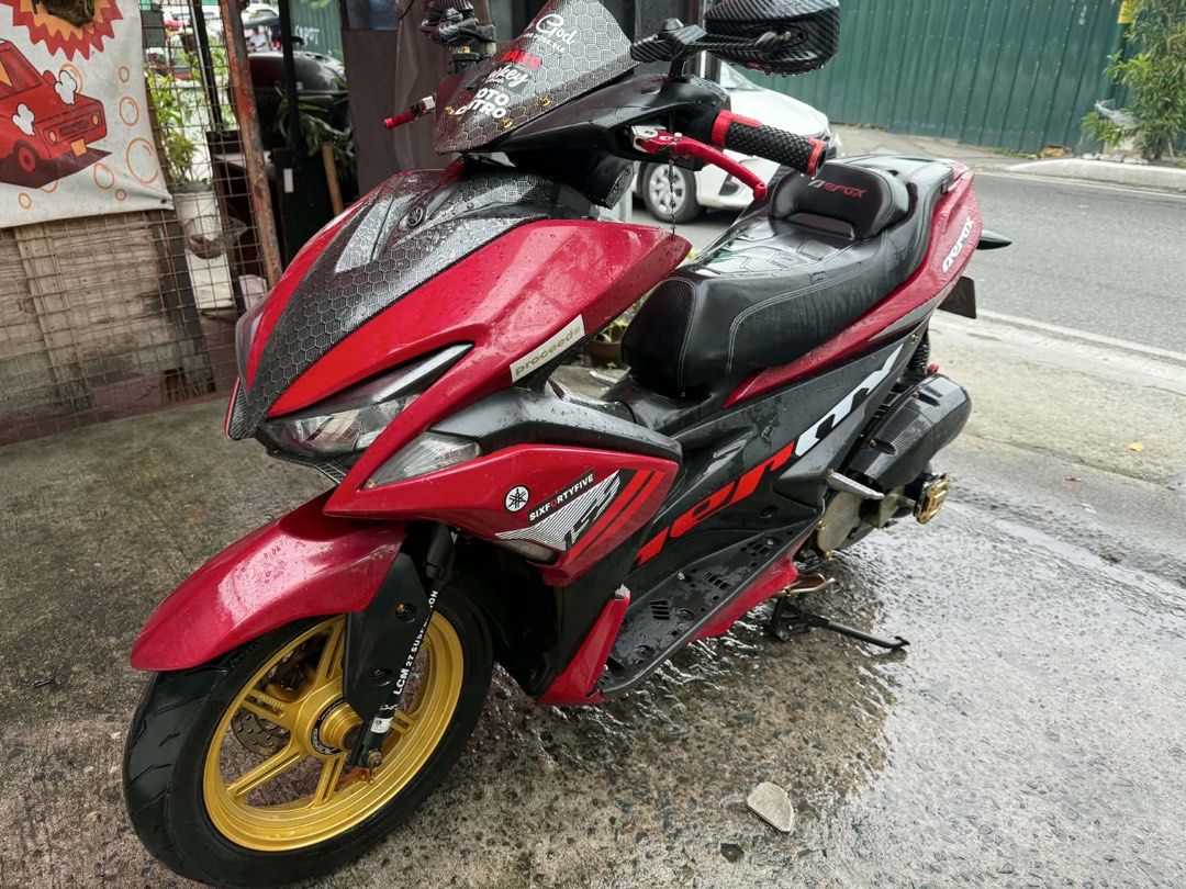 Yamaha Aerox 155cc Red and Black (Category: Motorbikes for Sale) located in Manila. Submitted by appleparadise (Listing ID 1459796692, Image 3). Description: Yamaha Aerox 155cc for sale. Red and black color scheme. Custom gold rims and aftermarket exhaust. Ready for the road. Low mileage. Well maintained. Serious buyers only. Message for inquiries. YAMAHA AEROX VERSION 1 2019 MODEL ORIG OR CR OPEN DEED OF SALE ID 1ST ONWER WITH 3 SIGN REGISTER 47