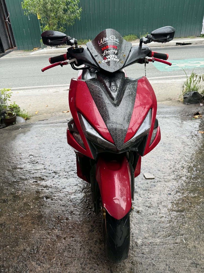 Yamaha Aerox 155cc Red and Black (Category: Motorbikes for Sale) located in Manila. Submitted by appleparadise (Listing ID 1459796692, Image 2). Description: Yamaha Aerox 155cc for sale. Red and black color scheme. Custom gold rims and aftermarket exhaust. Ready for the road. Low mileage. Well maintained. Serious buyers only. Message for inquiries. YAMAHA AEROX VERSION 1 2019 MODEL ORIG OR CR OPEN DEED OF SALE ID 1ST ONWER WITH 3 SIGN REGISTER 47