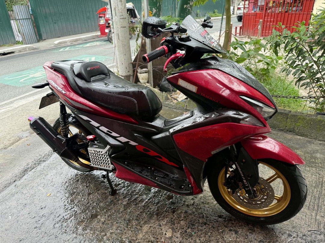 Yamaha Aerox 155cc Red and Black (Category: Motorbikes for Sale) located in Manila. Submitted by appleparadise (Listing ID 1459796692, Image 1). Description: Yamaha Aerox 155cc for sale. Red and black color scheme. Custom gold rims and aftermarket exhaust. Ready for the road. Low mileage. Well maintained. Serious buyers only. Message for inquiries. YAMAHA AEROX VERSION 1 2019 MODEL ORIG OR CR OPEN DEED OF SALE ID 1ST ONWER WITH 3 SIGN REGISTER 47