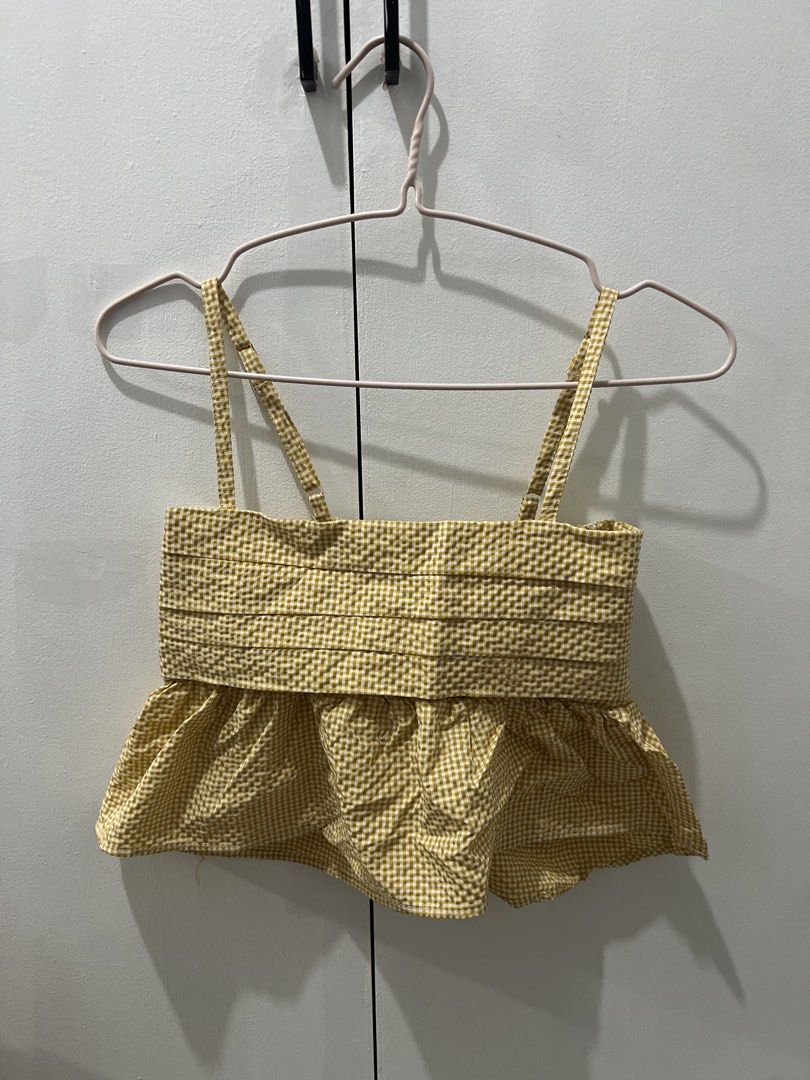 Yellow Gingham Peplum Top with Ruffle Hem (Category: Sleeveless) located in Taguig. Submitted by oceanwaves21 (Listing ID 1459844010, Image 1). Description: - Adorable yellow gingham peplum top - Features a flattering square neckline and thin straps - Ruched bodice for a stylish fit - Playful ruffle hem detail - Versatile for casual outings or dressing up - Easily pairs with shorts or skirts.