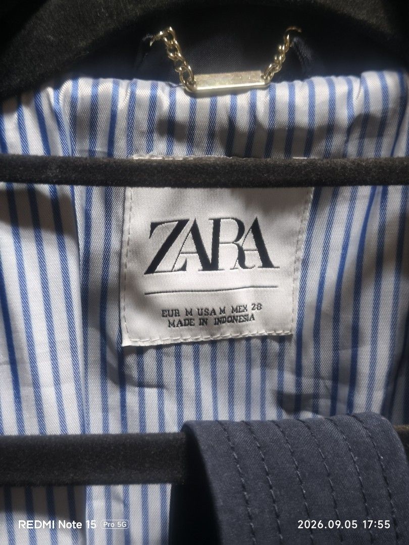 ZARA Double Breasted Navy Trench Coat (Category: Coats, Jackets and Outerwear) located in Cainta. Submitted by condoandstuff (Listing ID 1459793040, Image 3). Description: - Navy blue trench coat from ZARA - Double-breasted with button closure - Belted waist and adjustable cuffs - Classic trench details: epaulets and storm flap - Fully lined interior - Ideal for layering.
