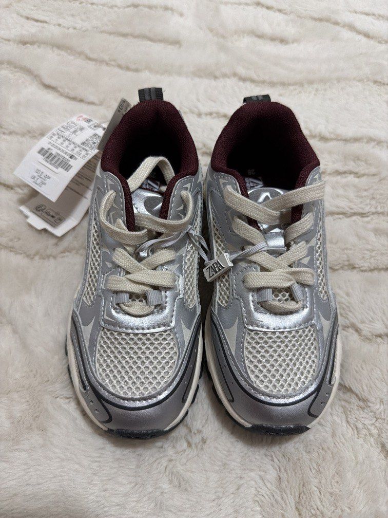Zara Kids Sneakers (Category: Babies & Kids Fashion) located in Cebu City. Submitted by sipandshopcebu (Listing ID 1459837825, Image 1). Description: ✨ BRAND NEW / NEVER WORN — WITH TAGS Zara kids sneakers in a metallic silver/grey with burgundy details. Super cute and easy to style — great for everyday wear. • Brand: ZARA • Size: EU 28 / US 11 / UK 10 • Color: Metallic silver/grey + burgundy • Condition: Brand new, never worn • Original tags att