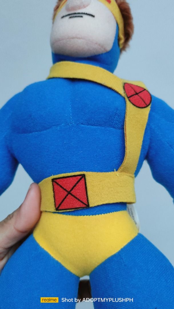 17" Kellytoy Marvel X-Men Cyclops Plush Figure (Category: Plushies & Soft Toys) located in Taguig. Submitted by adopt.my.plush.ph (Listing ID 1459915323, Image 3). Description: Character: Cyclops (Scott Summers) from Marvel's X-Men. Design Era: This specific muscular, streamlined plush design belongs to the Ultimate Marvel comic line aesthetic launched in the early 2000s. It features his signature ruby-quartz visor, a blue bodysuit, yellow boots,