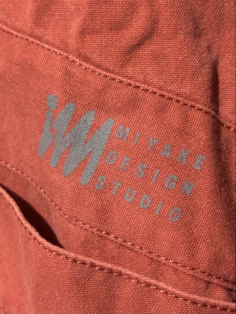 1980s Archival Issey Miyake Red Button-Up jacket (Category: Coats, Jackets and Outerwear) located in Manila. Submitted by why_notph (Listing ID 1460100839, Image 2). Description: - Red jacket from MIYAKE DESIGN STUDIO - Features a stylish mandarin collar - Button-up front closure - Three functional pockets: two large front pockets and one smaller chest pocket - Elasticated cuffs with button detail for a snug fit - Made from durable fabric - Versa