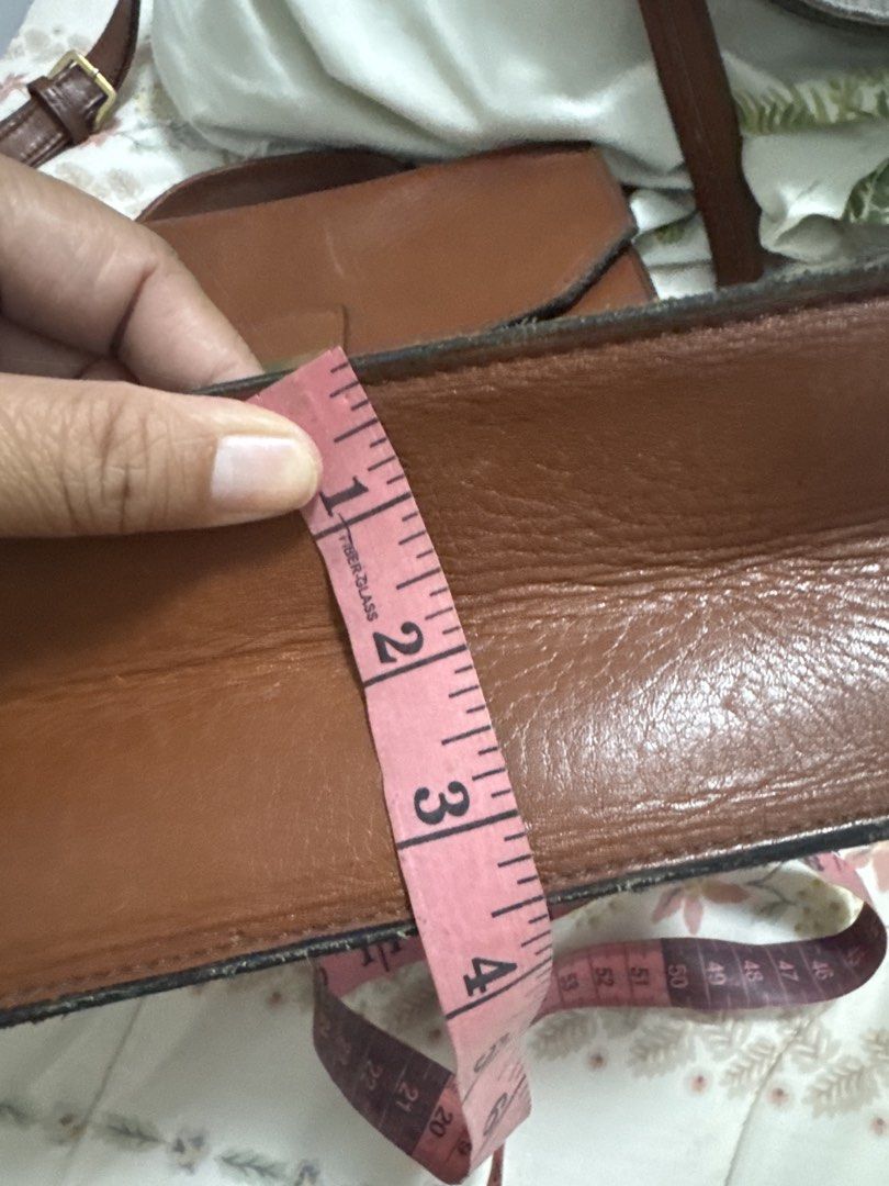 2027 Brown Leather Handbag with Brass Hardware (Category: Luxury Bags & Wallets) located in Silang. Submitted by sari2bilina (Listing ID 1459927524, Image 3). Description: - Classic brown leather handbag - Two front pockets with brass clasps - Spacious main compartment - Adjustable shoulder strap - Ideal for everyday use or work - Approximate dimensions: 10 inches tall x 8 inches wide with japanese character sa loob.