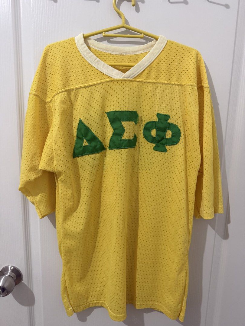70s 80s Yellow Delta Sigma Phi Jersey Shirt 20 (Category: Tshirts & Polo Shirts ) located in Manila. Submitted by driftthrift (Listing ID 1460068558, Image 1). Description: - Yellow mesh jersey shirt - Green Delta Sigma Phi letters on front - Number 20 on back - V-neck collar with white trim - Suitable for events or casual wear - Shows some signs of wear.