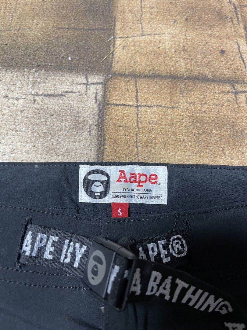AAPE BY A BATHING APE® Shorts Black Size S (Category: Shorts) located in Manila. Submitted by noahcastilljos363 (Listing ID 1459954958, Image 3). Description: - Brand: AAPE - Color: Black - Size: S - Features iconic ape head logo - Skull graphic on the back - Includes AAPE branded belt - Front zipper pockets - Ideal for casual wear.