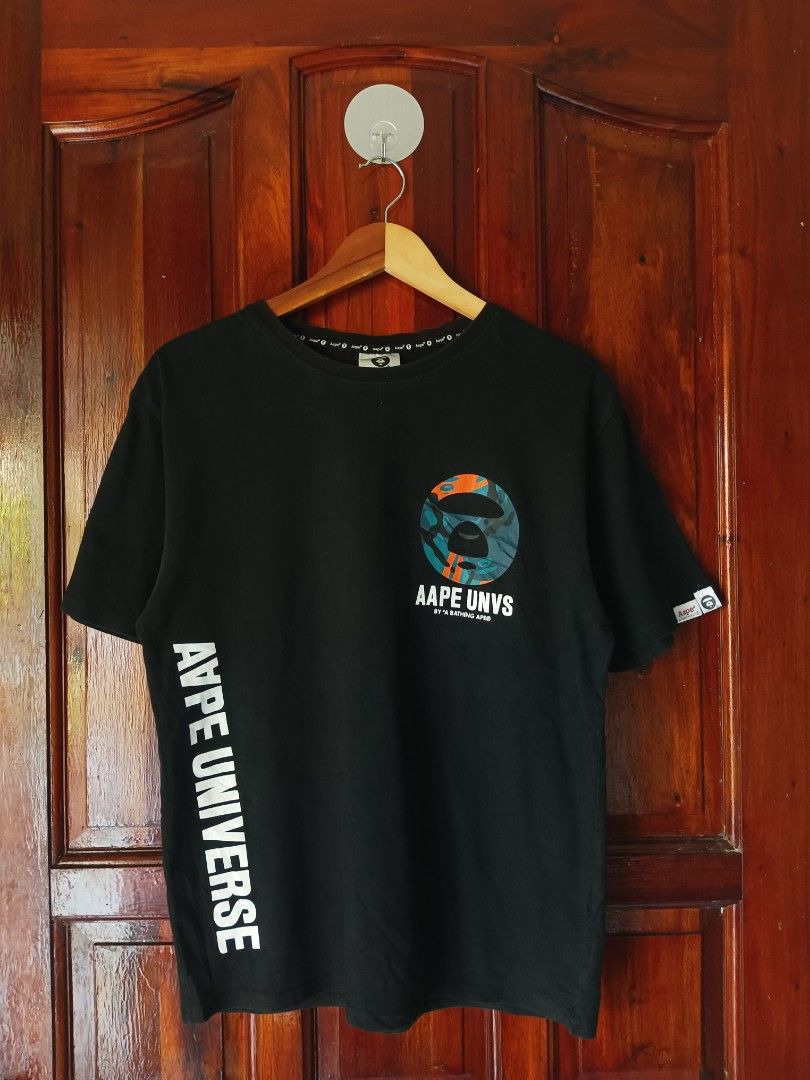 AAPE BY A BATHING APE T-shirt Black (Category: Blouses) located in Tagbilaran City. Submitted by kennlouise13 (Listing ID 1459979440, Image 2). Description: - Black AAPE BY A BATHING APE t-shirt - Features AAPE UNVS graphic on the front - Circular graphic on the back with text 'Somewhere in the Aape Universe' - Small logo detail on the sleeve - Perfect for casual everyday wear.