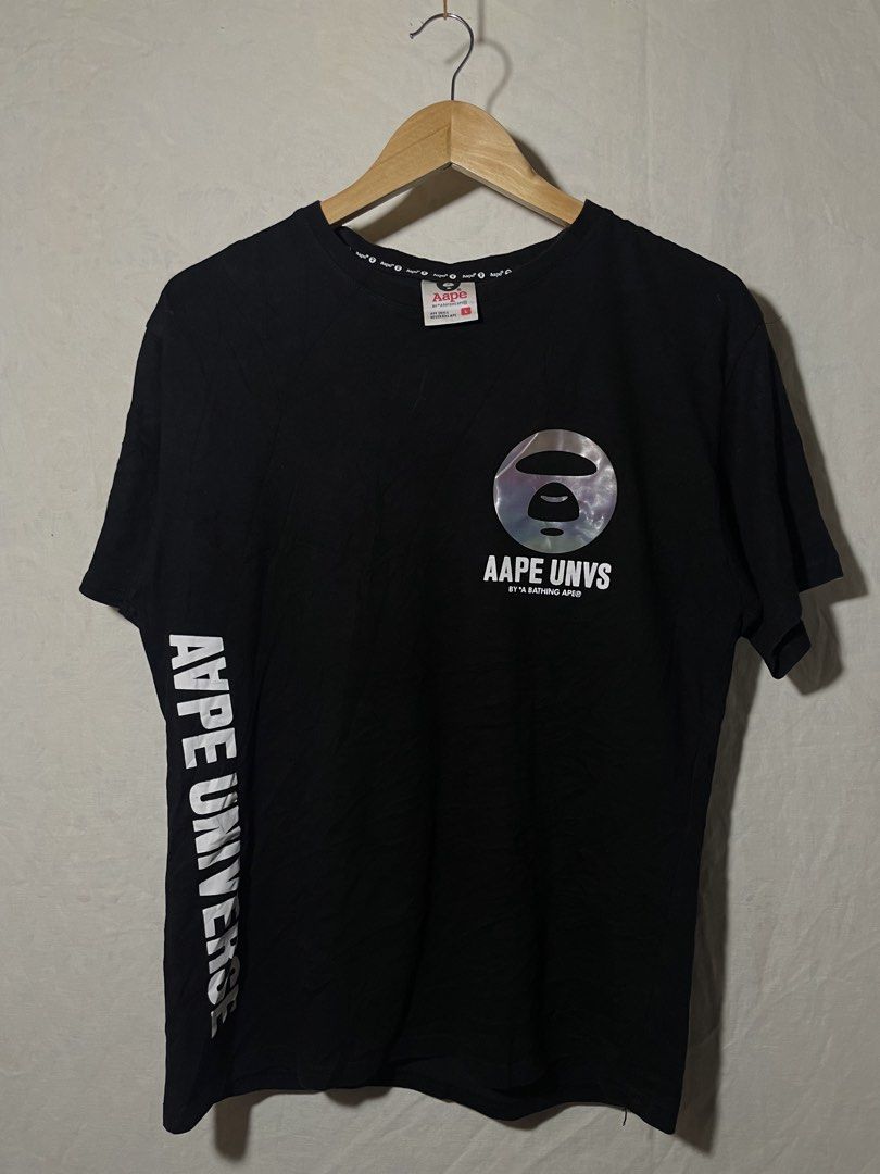 AAPE BY A BATHING APE Universe Graphic Tee (Category: Tshirts & Polo Shirts ) located in Sultan Kudarat. Submitted by ronajanoqu46791 (Listing ID 1459932472, Image 1). Description: - Authentic AAPE by A Bathing Ape Universe Tee - Color: Black - Size: L - Features a circular graphic on the back with the ape head logo and text - Text detail down the left sleeve - Smaller AAPE logo graphic on the front - Refer to tags for additional information.