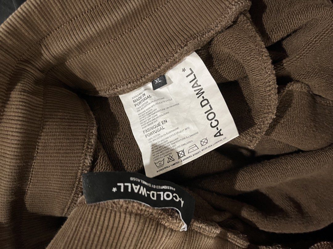 A-COLD-WALL* Brown Bleached Logo Sweatpants Size XL (Category: Joggers) located in Caloocan City. Submitted by jp.racan01 (Listing ID 1460007845, Image 3). Description: - Brand: A-COLD-WALL* - Color: Brown - Design: All-over bleached effect - Logo: ACW logo on leg - Origin: Made in Portugal - Features: Elastic waistband with drawstring, ribbed cuffs - Style: Ideal for casual wear Condition 9/10 Size XL 32 - 40 Length 104cm No issue.