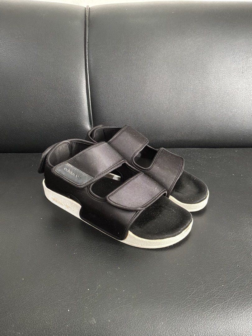 Adidas Adilette Sandals Black (Category: Casual Shoes) located in Quezon City. Submitted by kyleher (Listing ID 1460018350, Image 2). Description: - Black Adidas sandals - Two adjustable velcro straps - Easy slip-on design - Ideal for casual wear.