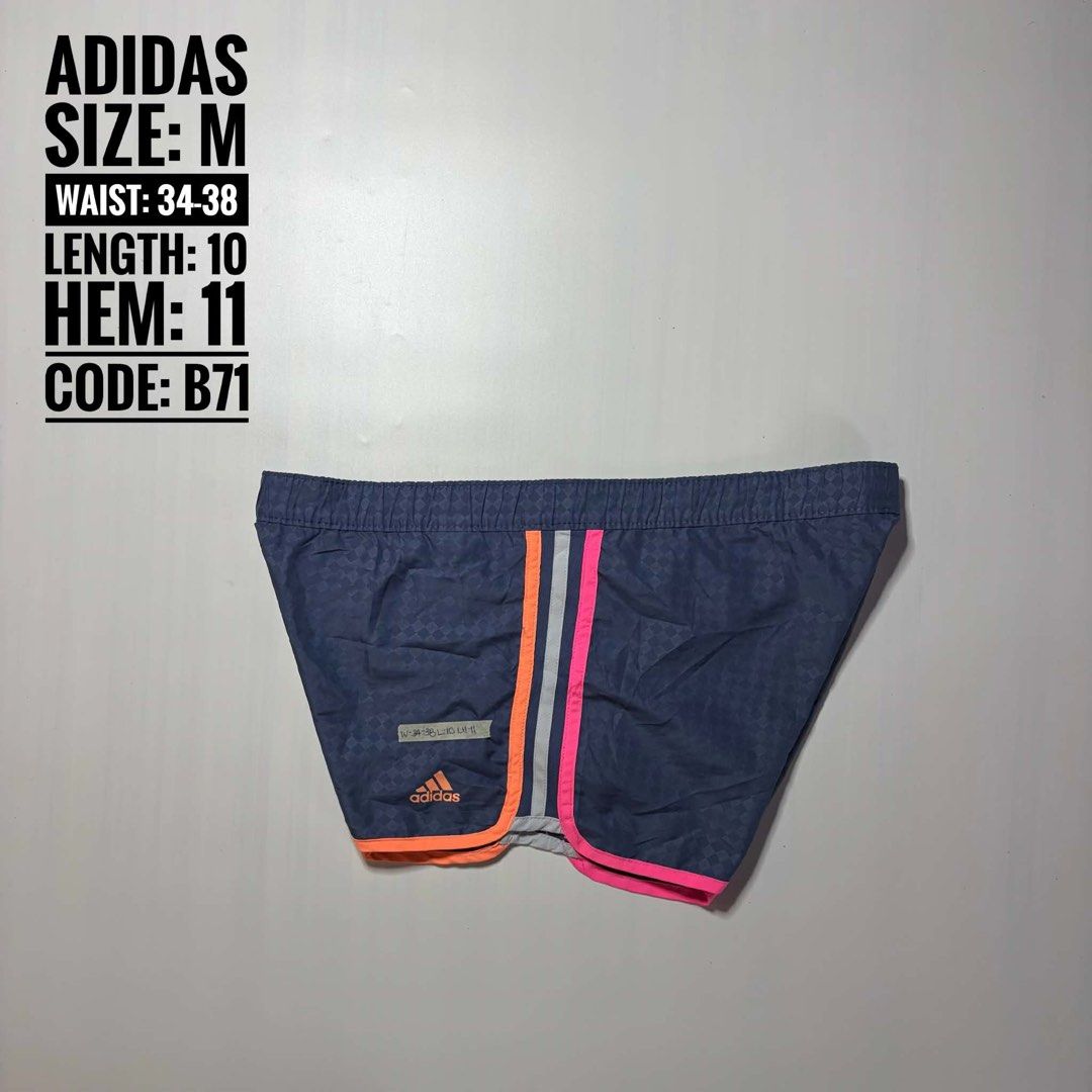 Adidas ClimaLite Athletic Shorts Size M (Category: Shorts) located in Baguio. Submitted by cosmogyralfinds (Listing ID 1460057503, Image 1). Description: - Navy blue Adidas shorts - Checkered pattern with bright pink and orange trim - ClimaLite fabric for excellent breathability - Elastic waistband with drawstring for a secure fit - Ideal for running, workouts, or casual wear - Size: Medium (fits waist 34-38 inches).
