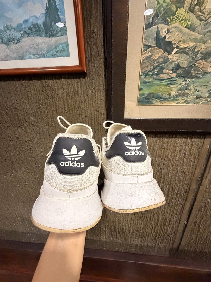 Adidas White Sneakers (Category: Casual Shoes) located in Manila. Submitted by cosmicriver-f451 (Listing ID 1459996915, Image 1). Description: - Classic white Adidas sneakers - Features iconic three stripes on the side - Perfect for everyday wear - Minor signs of use on soles and edges - Plenty of wear left, great bargain! - Negotiable .