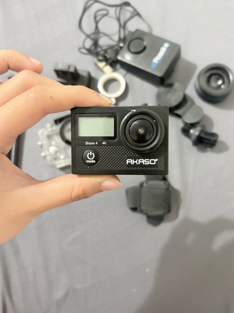 AKASO Brave 4 4K Action Camera with Accessories (Category: Cameras) located in Baguio. Submitted by cosmogyralfinds (Listing ID 1459957991, Image 2). Description: - AKASO Brave 4 Action Camera - Shoots in stunning 4K resolution - Includes waterproof case for underwater adventures - Comes with mini tripod, remote control, and various mounting accessories - Tested and confirmed to be in working condition - Ideal for capturing all your exciting esca