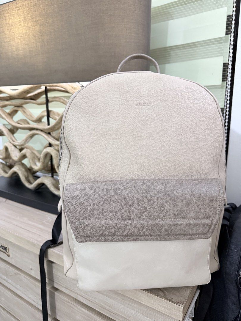 ALDO Tristian Beige Men Backpack (Category: Backpacks) located in Pasig City. Submitted by iambernabe (Listing ID 1460039217, Image 1). Description: - Elegant beige and taupe colorblock design - Convenient front pocket with flap closure - Adjustable straps for a comfortable fit - Spacious main compartment with zipper closure - Ideal for everyday errands or your next getaway.