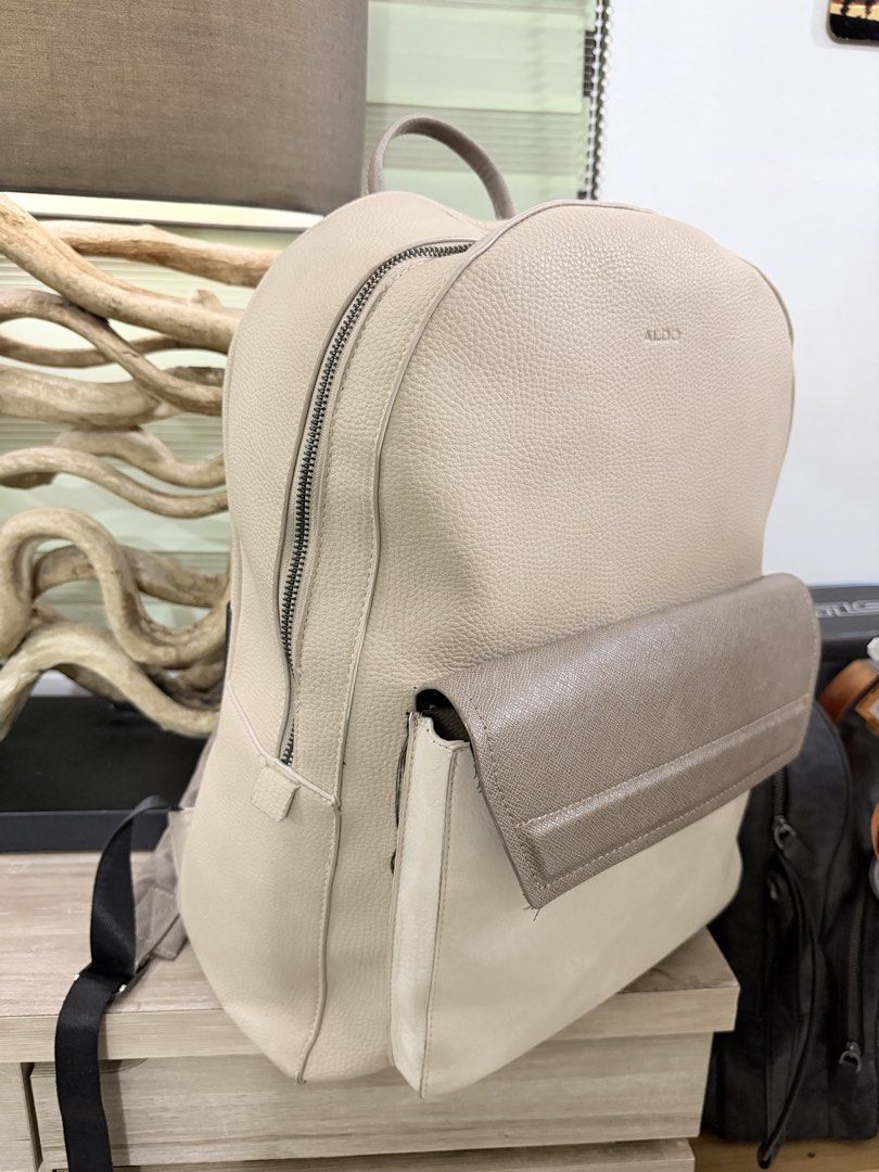 ALDO Tristian Beige Men Backpack (Category: Backpacks) located in Pasig City. Submitted by iambernabe (Listing ID 1460039217, Image 2). Description: - Elegant beige and taupe colorblock design - Convenient front pocket with flap closure - Adjustable straps for a comfortable fit - Spacious main compartment with zipper closure - Ideal for everyday errands or your next getaway.