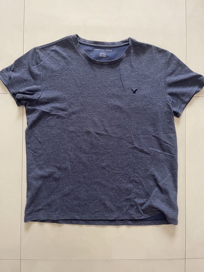 American Eagle Men's Blue T-shirt Size L (Category: Tshirts & Polo Shirts ) located in Quezon City. Submitted by kingcurator (Listing ID 1459970185, Image 1). Description: - Brand: American Eagle - Color: Blue - Size: L - Fit: Standard - Features: Embroidered classic eagle logo on chest - Origin: Made in Indonesia - Measurements: Pit to pit approx. 22 inches, Length approx. 29 inches - Ideal for: Casual wear.