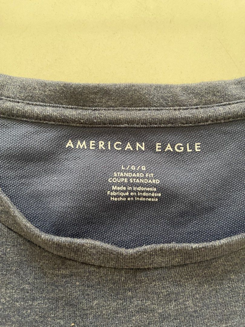 American Eagle Men's Blue T-shirt Size L (Category: Tshirts & Polo Shirts ) located in Quezon City. Submitted by kingcurator (Listing ID 1459970185, Image 3). Description: - Brand: American Eagle - Color: Blue - Size: L - Fit: Standard - Features: Embroidered classic eagle logo on chest - Origin: Made in Indonesia - Measurements: Pit to pit approx. 22 inches, Length approx. 29 inches - Ideal for: Casual wear.