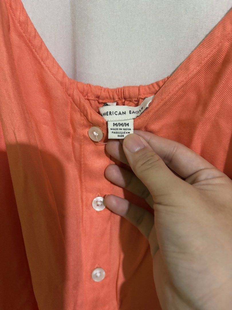 American Eagle Orange Dress (Category: Dresses) located in Manila. Submitted by prelovedbtsmerch_ph (Listing ID 1459943713, Image 2). Description: - Size: Medium - Button front detail - Ties at the back for adjustable fit.