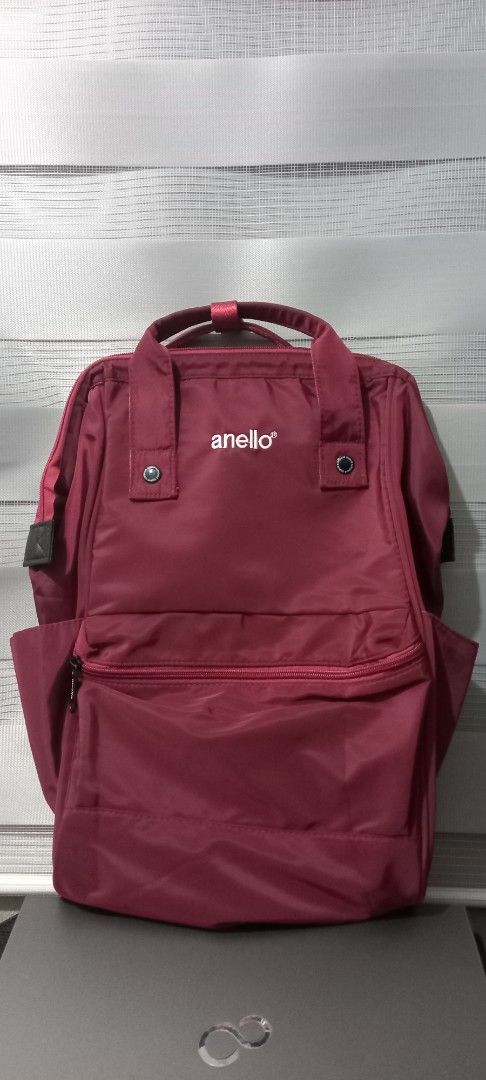 Anello Backpack Burgundy (Category: Backpacks) located in San Fernando. Submitted by surceeshop (Listing ID 1460101625, Image 1). Description: - Anello backpack in a rich maroon color. - Convenient front zip pocket for essentials. - Two side pockets for easy access to water bottles or umbrellas. - Comfortable adjustable padded straps for easy carrying. - Ample interior space, perfect for daily commutes or travel adventures. -Never used..