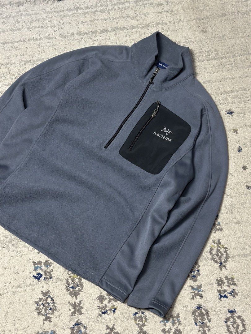 Arc'teryx Fleece Jacket Quarter Zip (Category: Coats, Jackets and Outerwear) located in Daet. Submitted by thrifthings2018 (Listing ID 1460022618, Image 3). Description: Width 21 length 26 - Grey Arc'teryx fleece jacket - Black zippered chest pocket with Arc'teryx logo - Quarter zip closure at the neck - Ideal for layering or standalone wear - Suitable for outdoor activities and casual use.