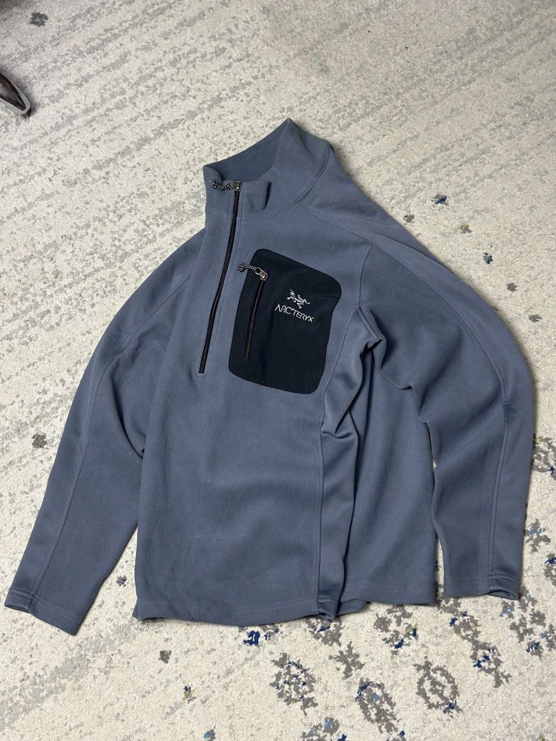 Arc'teryx Fleece Jacket Quarter Zip (Category: Coats, Jackets and Outerwear) located in Daet. Submitted by thrifthings2018 (Listing ID 1460022618, Image 2). Description: Width 21 length 26 - Grey Arc'teryx fleece jacket - Black zippered chest pocket with Arc'teryx logo - Quarter zip closure at the neck - Ideal for layering or standalone wear - Suitable for outdoor activities and casual use.