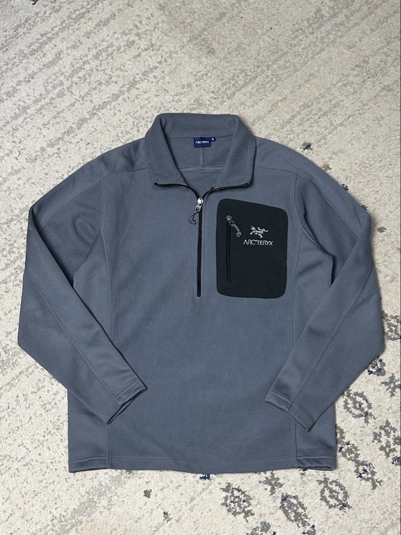 Arc'teryx Fleece Jacket Quarter Zip (Category: Coats, Jackets and Outerwear) located in Daet. Submitted by thrifthings2018 (Listing ID 1460022618, Image 1). Description: Width 21 length 26 - Grey Arc'teryx fleece jacket - Black zippered chest pocket with Arc'teryx logo - Quarter zip closure at the neck - Ideal for layering or standalone wear - Suitable for outdoor activities and casual use.