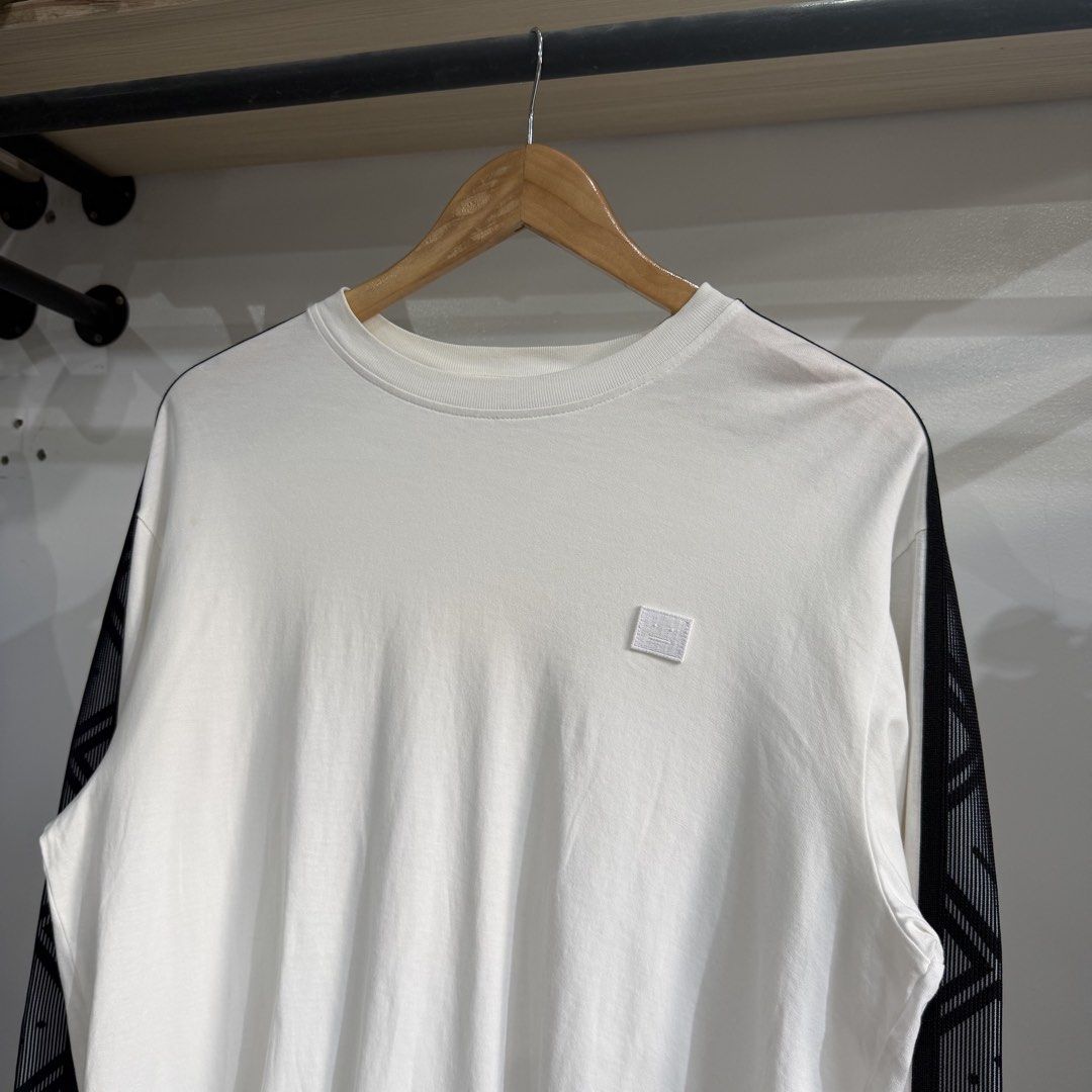 Authentic Acne Studios Face Patch Long-Sleeve T-Shirt (Category: Coats, Jackets and Outerwear) located in Bambang. Submitted by heats777 (Listing ID 1460085017, Image 1). Description: Excellent condition No issues featuring prominent black patterned sleeve stripes and a small chest patch detail Size: S.