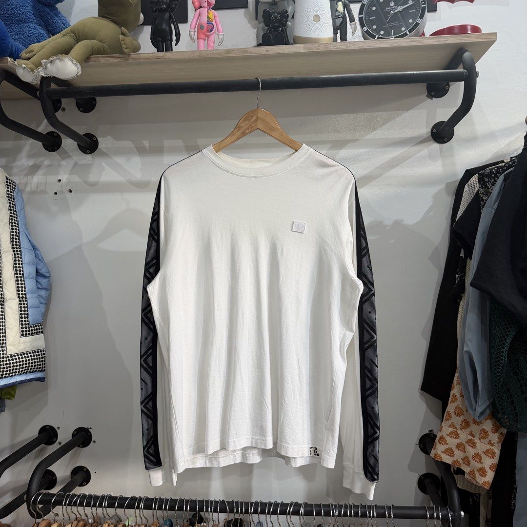 Authentic Acne Studios Face Patch Long-Sleeve T-Shirt (Category: Coats, Jackets and Outerwear) located in Bambang. Submitted by heats777 (Listing ID 1460085017, Image 2). Description: Excellent condition No issues featuring prominent black patterned sleeve stripes and a small chest patch detail Size: S.