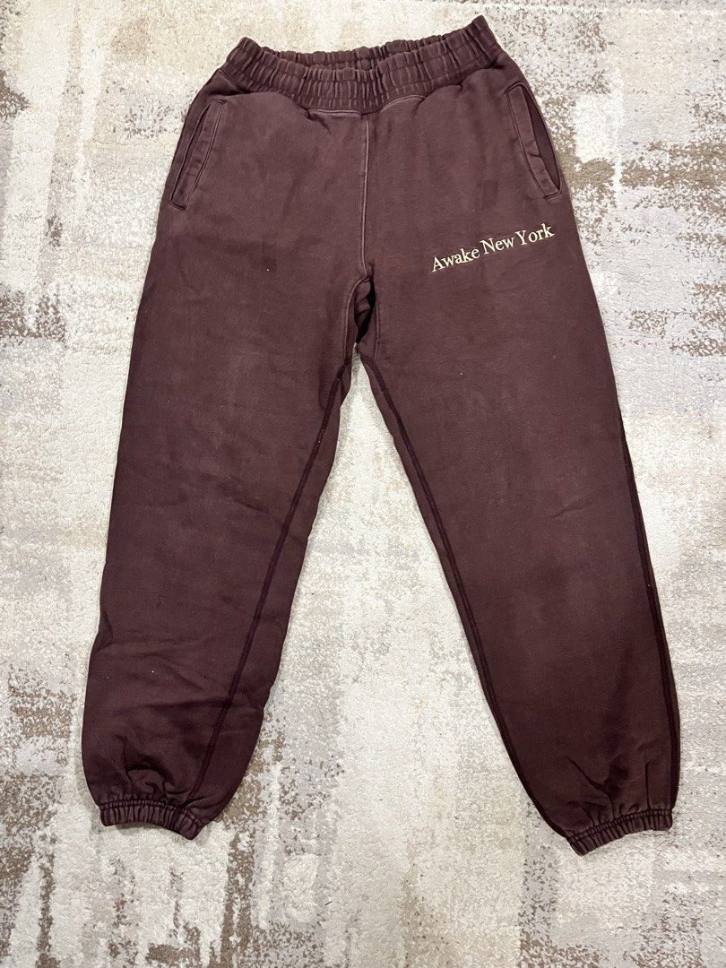 Awake New York Brown Sweatpants (Category: Joggers) located in Caloocan City. Submitted by jp.racan01 (Listing ID 1460008315, Image 1). Description: - Brand: Awake New York - Color: Brown - Features: Embroidered logo on front and back - Design: Elastic waistband and cuffs - Fit: Comfortable - Occasion: Casual wear Condition 9/10 Size 35/36 Length 107cm No issue.