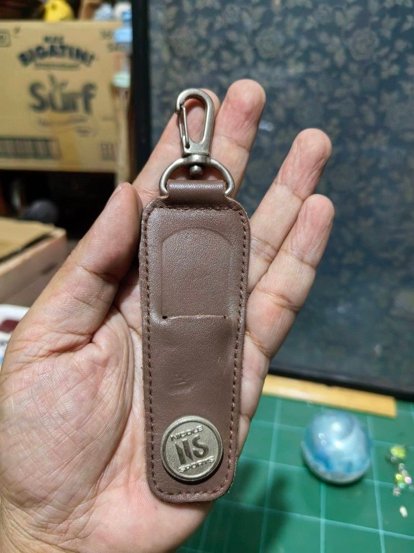 Bag Tag - Brown Leather Strap (Category: Other Accessories) located in Cebu City. Submitted by dudes_villanueva (Listing ID 1459934638, Image 1). Description: Bag Tag - Brown Leather Strap 📌 Featuring a silver-tone metal clasp at the top and a snap button at the bottom stamped with "Nicole Sports NS"..