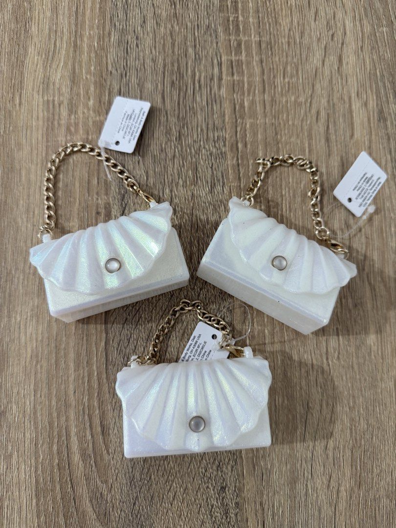 Bath & Body Works Shell Hand Sanitizer Holder with Chain (Category: Sanitizers & Disinfectants) located in Antipolo. Submitted by ritzkenzo_olshop06 (Listing ID 1459974226, Image 1). Description: - Set of 3 cute shell-shaped hand sanitizer holders. - Features elegant gold chain straps for easy bag attachment. - One holder comes with a mini vanilla bean hand sanitizer. - Ideal for convenient on-the-go sanitizing. - Bundle deal available for all th