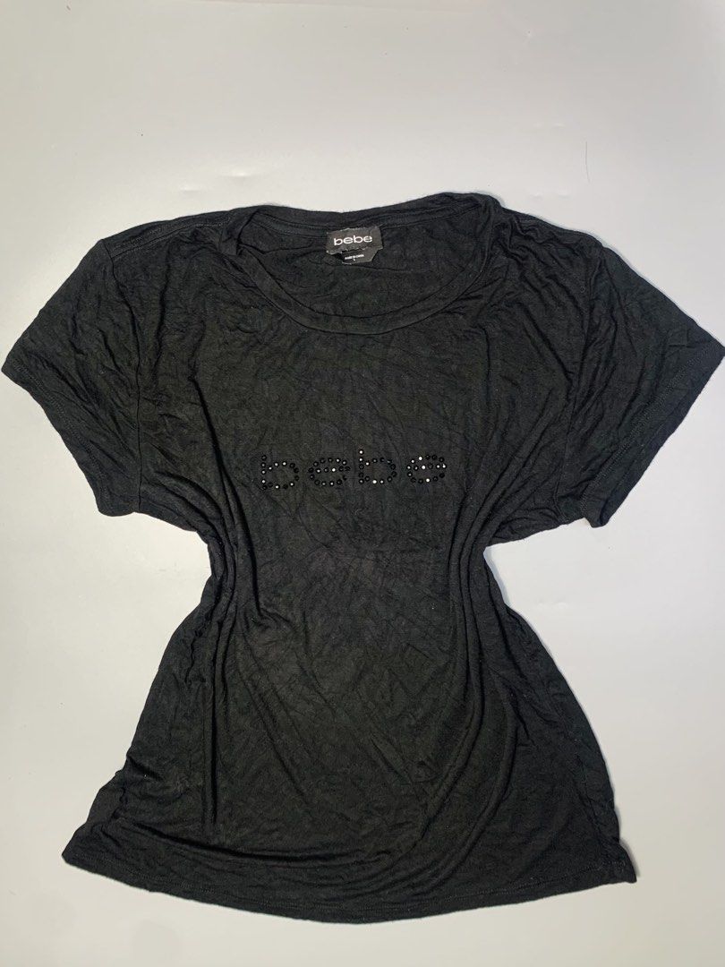 Bebe Black T-shirt with Rhinestone Logo (Category: Shirts) located in Dagupan City. Submitted by sj_styles0910. (Listing ID 1460096249, Image 1). Description: - Authentic Bebe tee with eye-catching rhinestone embellished logo. - Made from soft fabric for ultimate comfort. - Relaxed fit, ideal for everyday casual wear. - Effortlessly pairs with jeans, shorts, or skirts. - A timeless Bebe essential for your wardrobe..