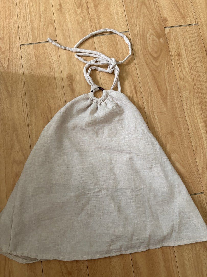 Beige Linen Halter Top with Ring Detail (Category: Sleeveless) located in Manila. Submitted by cassyandco. (Listing ID 1459950787, Image 1). Description: - Lightweight beige halter top - Features a wooden ring detail at the neckline - Adjustable tie-back closure - Textured fabric for a unique look - Ideal for casual wear, beach vacations, or pairing with shorts/skirts.